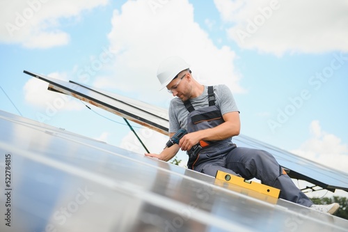 Worker installing solar panels outdoors