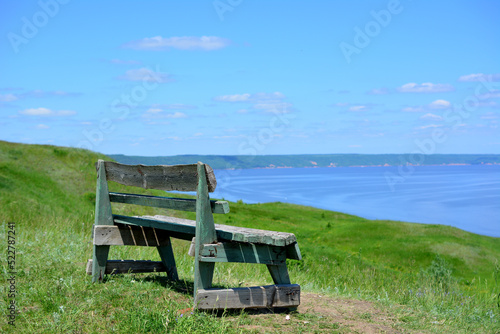 isolated bench on the top of the mountain with the view to the sea