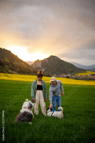 portrait of a couple in the mountains with her dogs