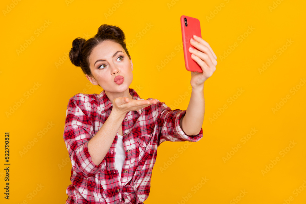 Photo of charming person take selfie arm palm send air kiss isolated on yellow color background Photo of charming person take selfie arm palm send air kiss isolated on yellow color background