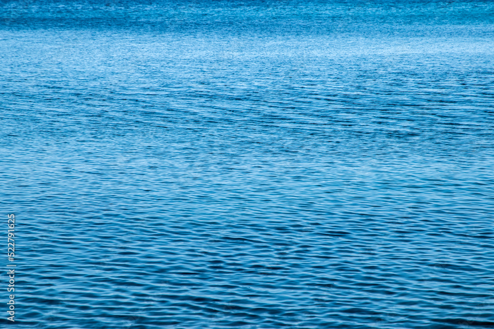 Obraz premium Clear calm blue sea waters surface closeup as water background
