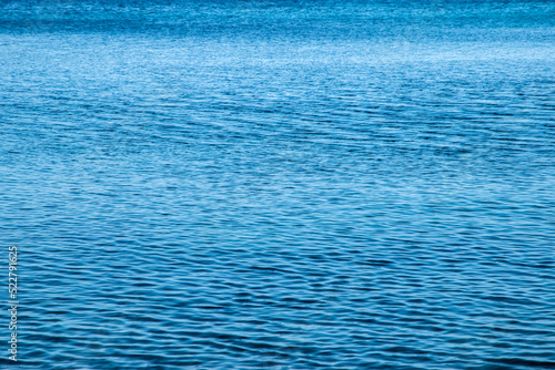 Clear calm blue sea waters surface closeup as water background