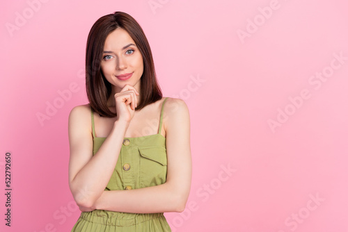 Photo of attractive nice thoughtful girl bob hairdo wear khaki overall finger on chin shopping decision isolated on pink color background