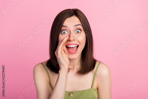 Photo of hooray brunette lady say secret wear khaki top isolated on pink color background photo