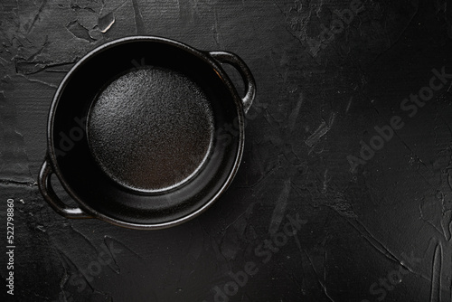 Empty cooking pot with copy space for text or food with copy space for text or food, top view flat lay , on black dark stone table background