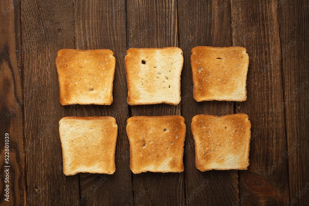 Set of six slices toast bread on wooden background