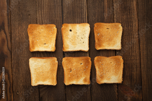 Set of six slices toast bread on wooden background