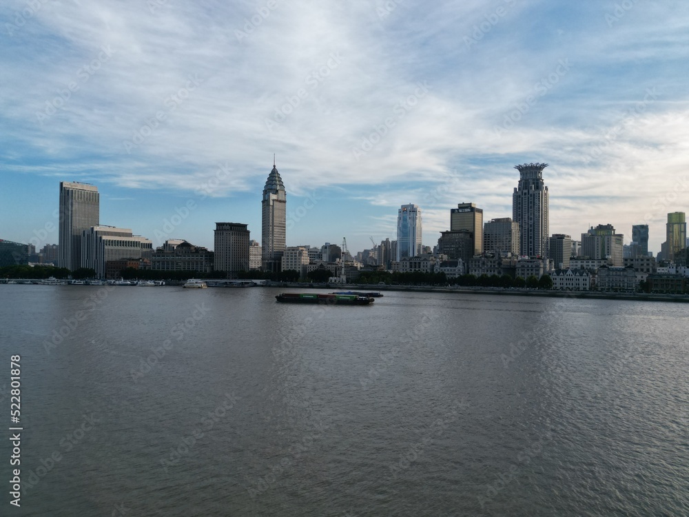 Flying with a drone over the Huangpu in Shanghai and taking in the views of the Bund with the sunset in the backdrop