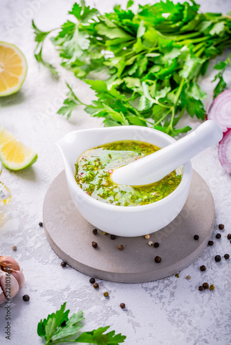 Chimichurri - homemade fresh Latin American sauce made from various herbs, garlic and red wine vinegar photo