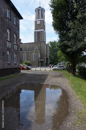 Church of Saint Joseph (Kosciol sw. Jozefa), the tower reflected in a puddle. Swietochlowice, Poland.