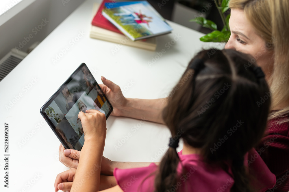 mother and daughter using digital tablet for online chatting from home mother and daughter using digital tablet for online chatting from home