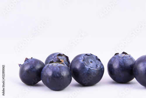 Selective focus  closeup of fresh blueberries against white background