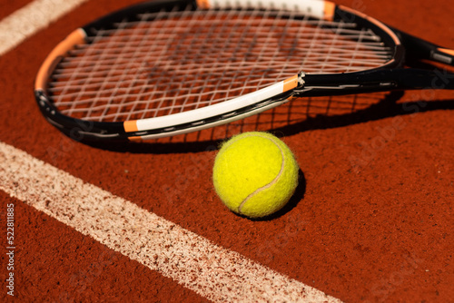 Broken tennis racket on clay tennis court