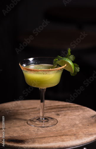 Green cocktail and lime garnish 