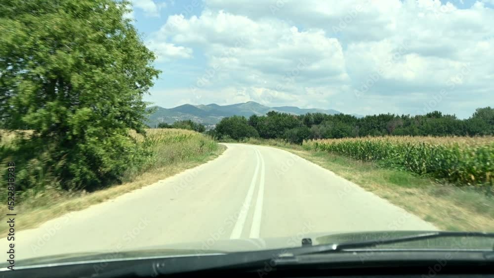 driving on rural road through fields on a sunny summer day 1 driving on rural road through fields on a sunny summer day 1