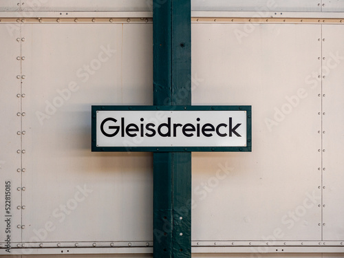 Gleisdreieck name board on the wall of the subway station. Sign with the train station in Berlin, Germany. Architecture of the public transportation in the city. Information at the platform.