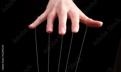 Hand manipulating and controlling smth with strings concept. High quality photo photo