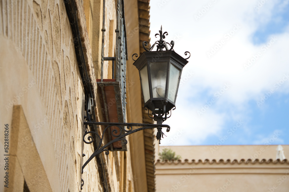 Street lamp in a street of a European Mediterranean style city. Seville and one of its central streets. Travel concept