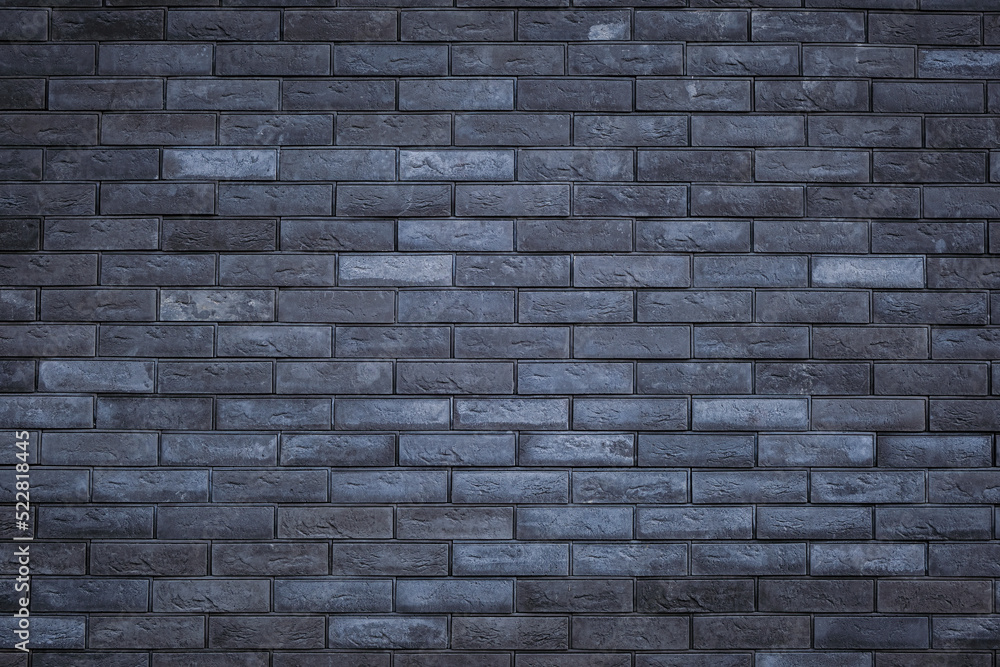 Dark grey brick tiles wall texture background. Backdrop for design.
