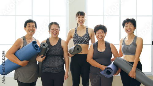 Portrait of Multi-generation woman, diverse age in family workout exercise and practice yoga together at gym