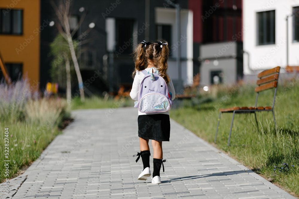 a little girl goes to school through the park along the path. distance education concept. schoolgirl returning home from school
a little girl goes to school through the park along the path. distance education concept. schoolgirl returning home from school