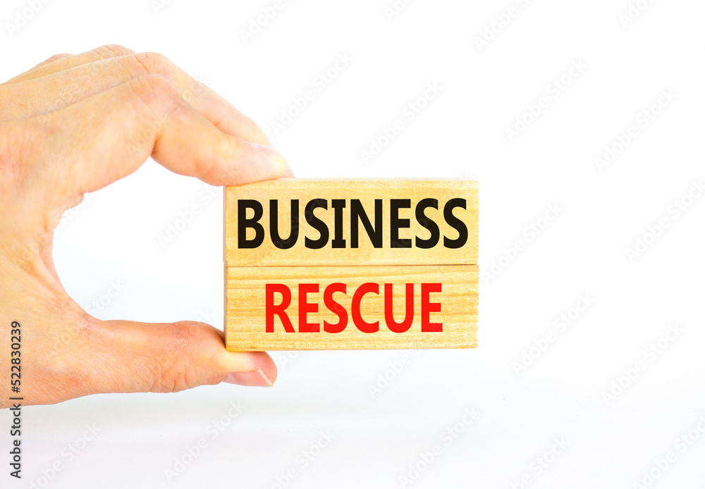 Business rescue symbol. Concept words Business rescue on wooden blocks on a beautiful white table white background. Businessman hand. Business rescue and support concept. Copy space. Business rescue symbol. Concept words Business rescue on wooden blocks on a beautiful white table white background. Businessman hand. Business rescue and support concept. Copy space.