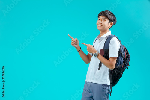 Indonesian male high school students wearing gray and white uniforms. Isolated on a Blue background.
