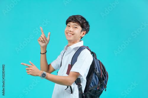 Indonesian male high school students wearing gray and white uniforms. Isolated on a Blue background.