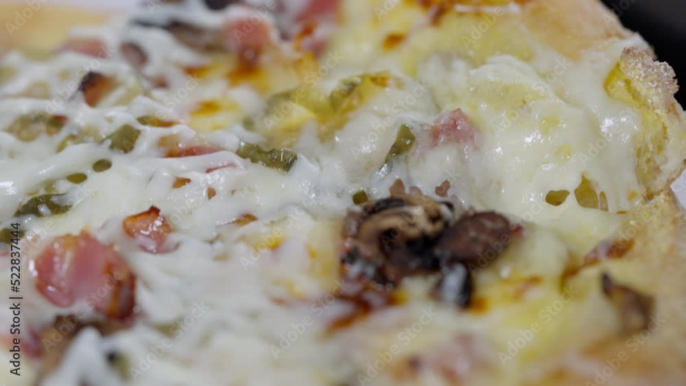 Close up on the delicious melted cheese on an Italian pizza Close up on the delicious melted cheese on an Italian pizza