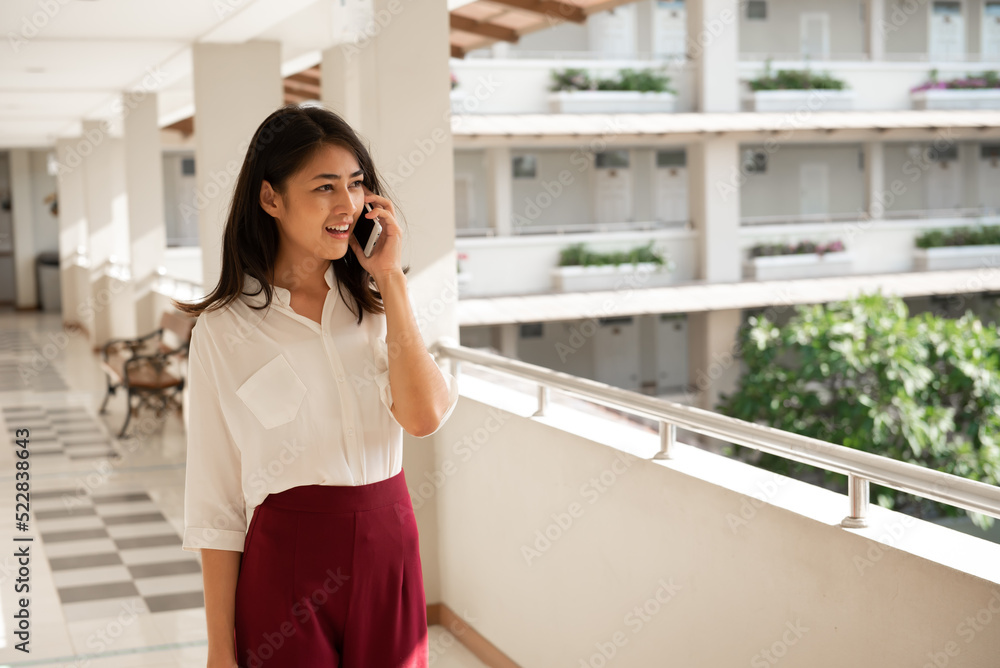 Young Asian woman talking on mobile phone. Young Asian woman talking on mobile phone.