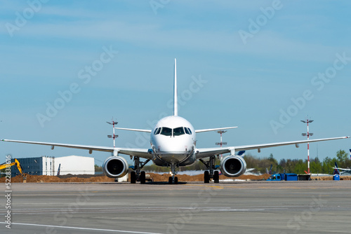 White twin-engine passenger plane on the tarmac of the international airport