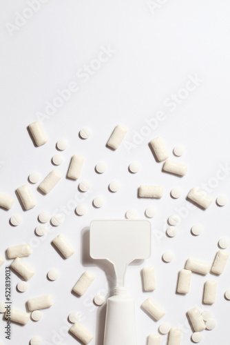 Titanium dioxide, E171, dangerous additive concept. gum, pills, toothpaste or cream and sign with space on white background. copy space