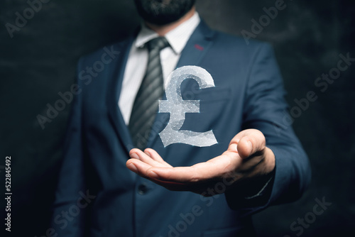 Fotografie Pound sterling icon from web. Man holding in his hand