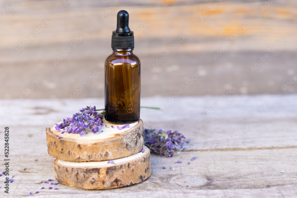 a bottle for cosmetics with an empty space for advertising lavender flowers on a wooden background A place for copying A place for advertising Lavender oil a bottle for cosmetics with an empty space for advertising lavender flowers on a wooden background A place for copying A place for advertising Lavender oil