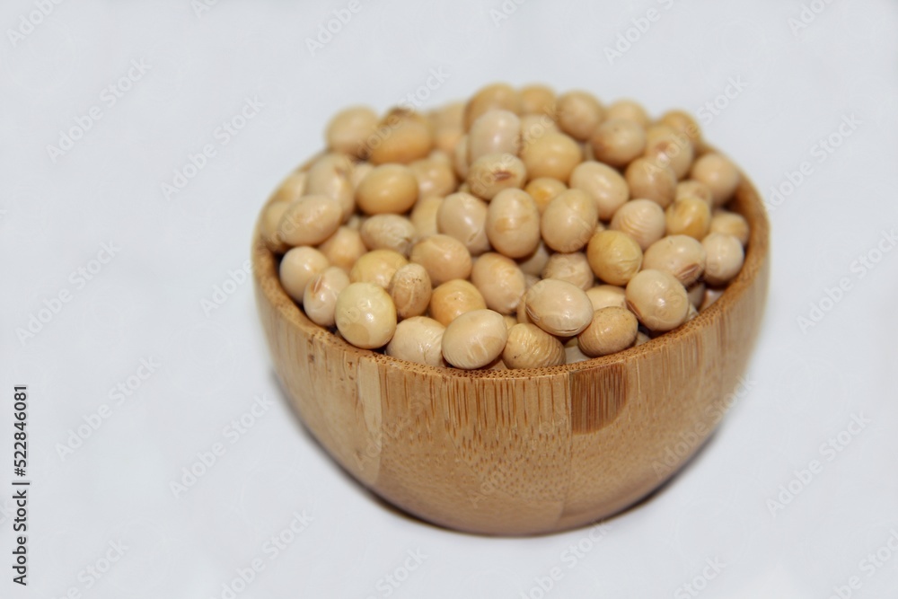 Soybeans (Glycine max) in a wooden bowl isolated on white background. Soybeans (Glycine max) in a wooden bowl isolated on white background.