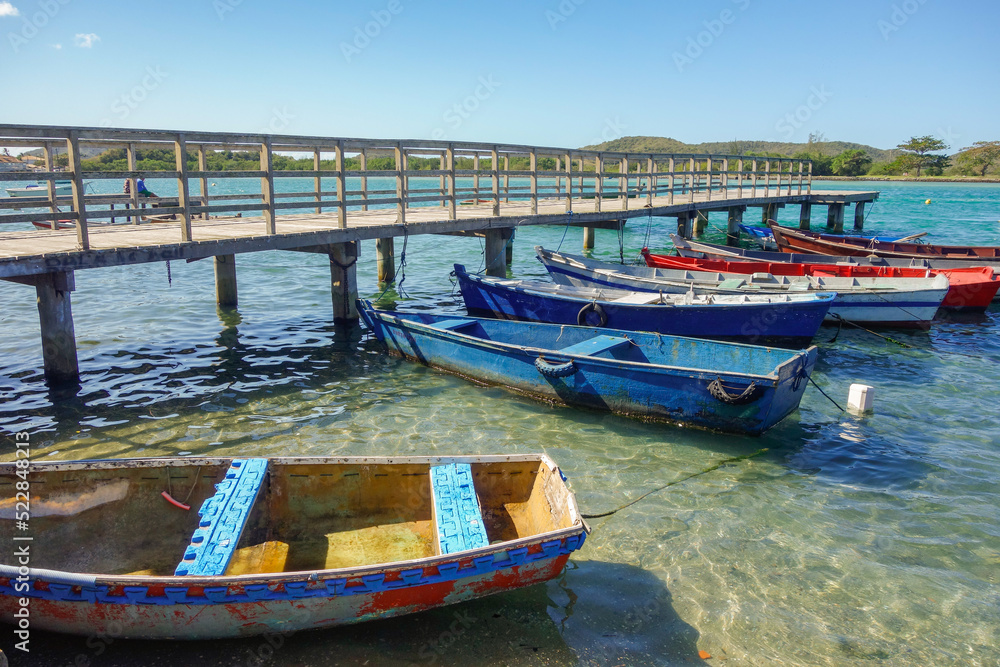 wooden fishing rafts moored beside a deck on tropical beach