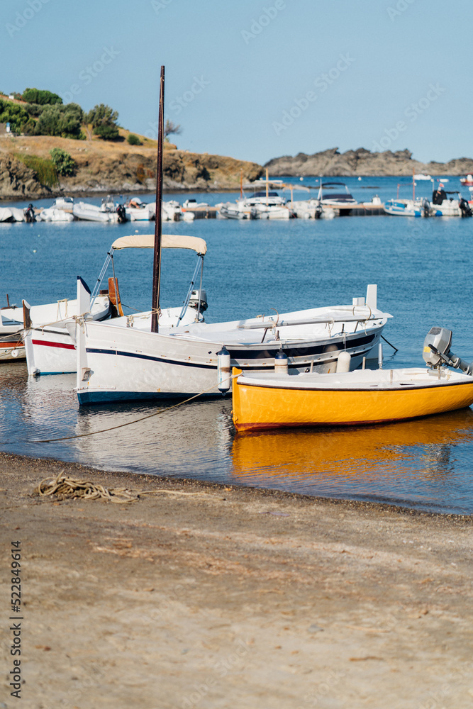 Barcos en la orilla frente a la costa de Cadaqués en la Costa Brava, Cataluña.
