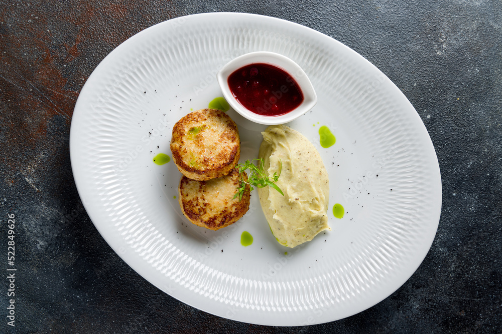 Chicken cutlets with mashed potatoes and sauce on white plate top view Chicken cutlets with mashed potatoes and sauce on white plate top view