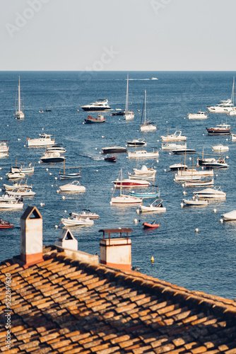 Barcos fondeados frente a la costa de Cadaqués en la Costa Brava, Cataluña. photo