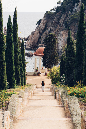 Chica paseando por jardín botánico de Marimurtra en Blanes, provincia de Girona, Costa Brava. photo