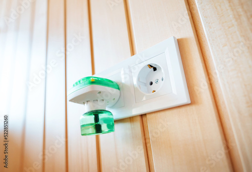 Anti-mosquito fumigator, electric fumigator plugged into a socket of a modern home. photo