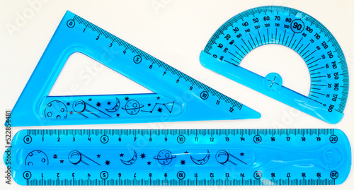 triangular ruler and blue protractor for school on white background