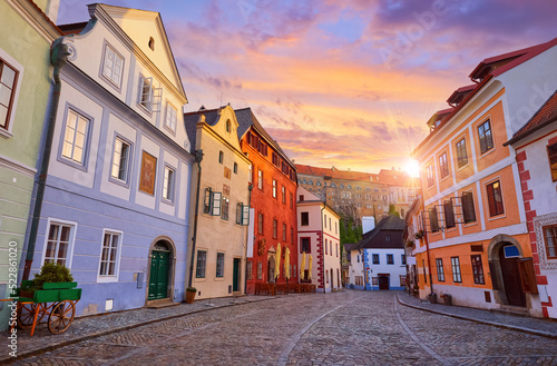 Cesky Krumlov  Czech Republic. Ancient street with old houses and paving stones road. Evening sunset with sunlight.