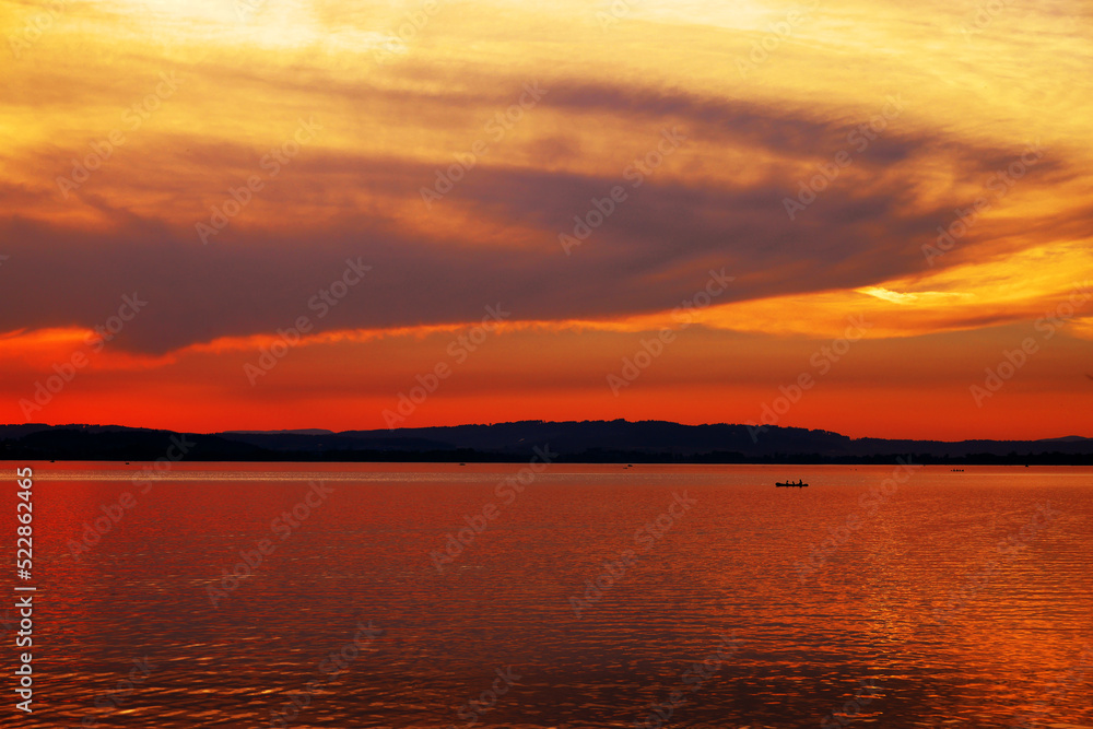 Beautiful orange sunset at Sempach Lake, Switzerland. Sunset sky image of tropical sunset. Summer vacation travel card or banner template
Beautiful orange sunset at Sempach Lake, Switzerland. Sunset sky image of tropical sunset. Summer vacation travel card or banner template