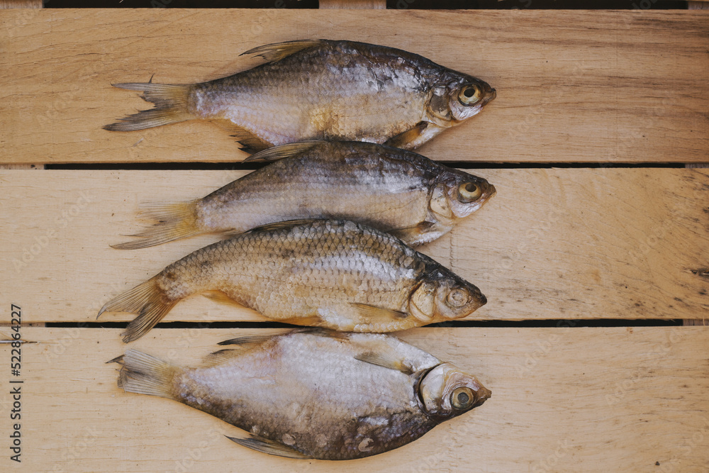 dried roach fish on a wooden background, beer snack dried roach fish on a wooden background, beer snack
