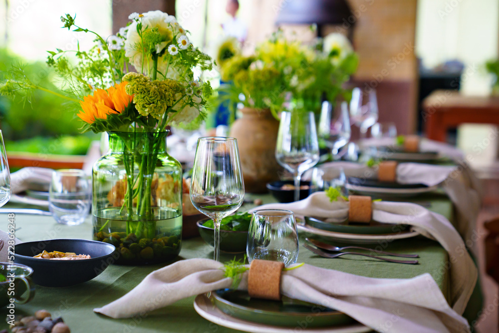 beautiful setting of a large table with flowers. 