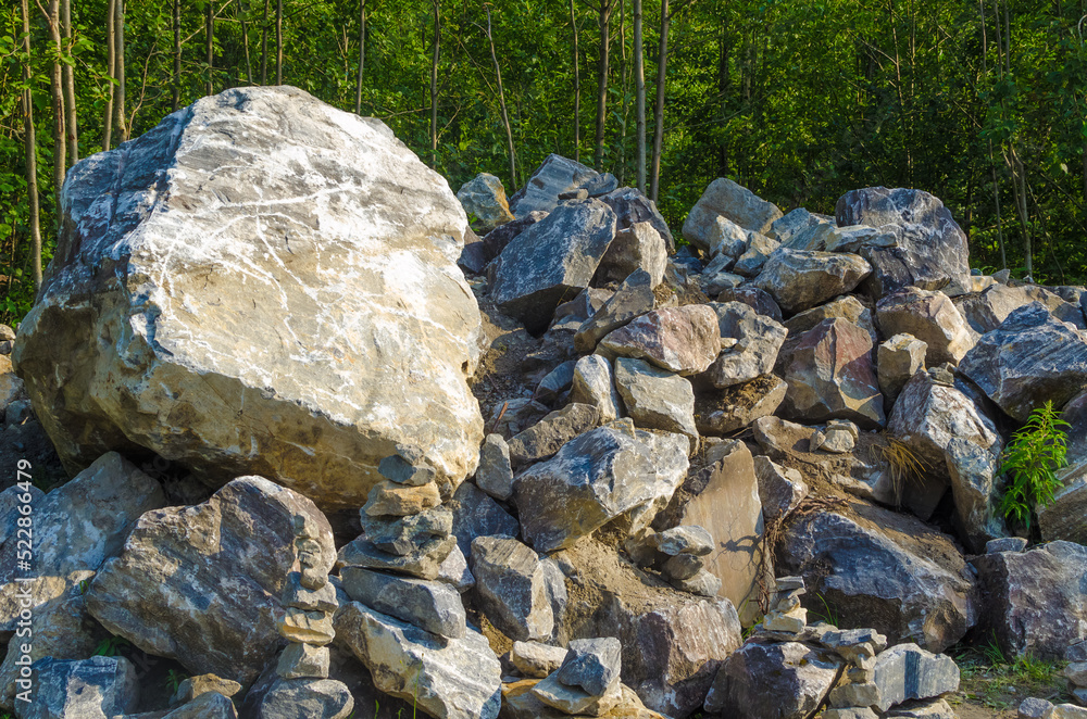 Mountain of stones in the forest in summer