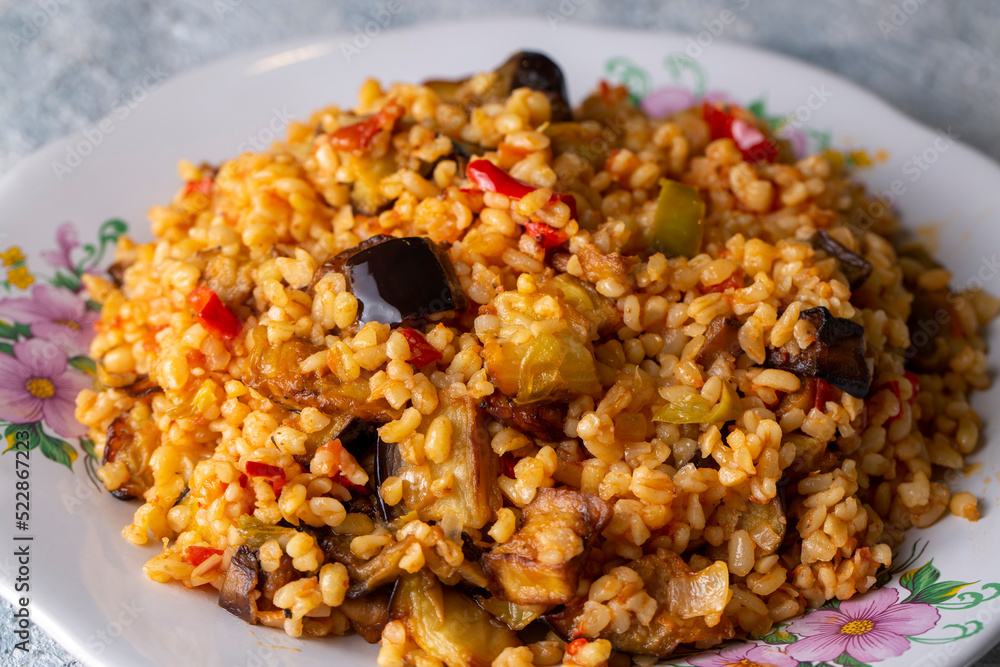 Traditional delicious Turkish food; Bulgur pilaf with eggplant and vegetables. (Turkish name; Patlicanli bulgur pilavi) Traditional delicious Turkish food; Bulgur pilaf with eggplant and vegetables. (Turkish name; Patlicanli bulgur pilavi)