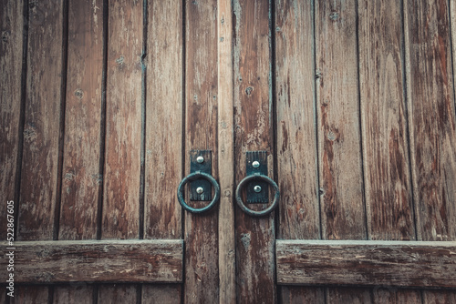 Medieval style old wooden door with metal handle