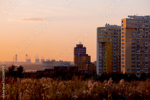 Banner. A beautiful orange sunset over the city of Vidnoye. The outline of the city on the horizon. Skyscrapers and residential buildings.